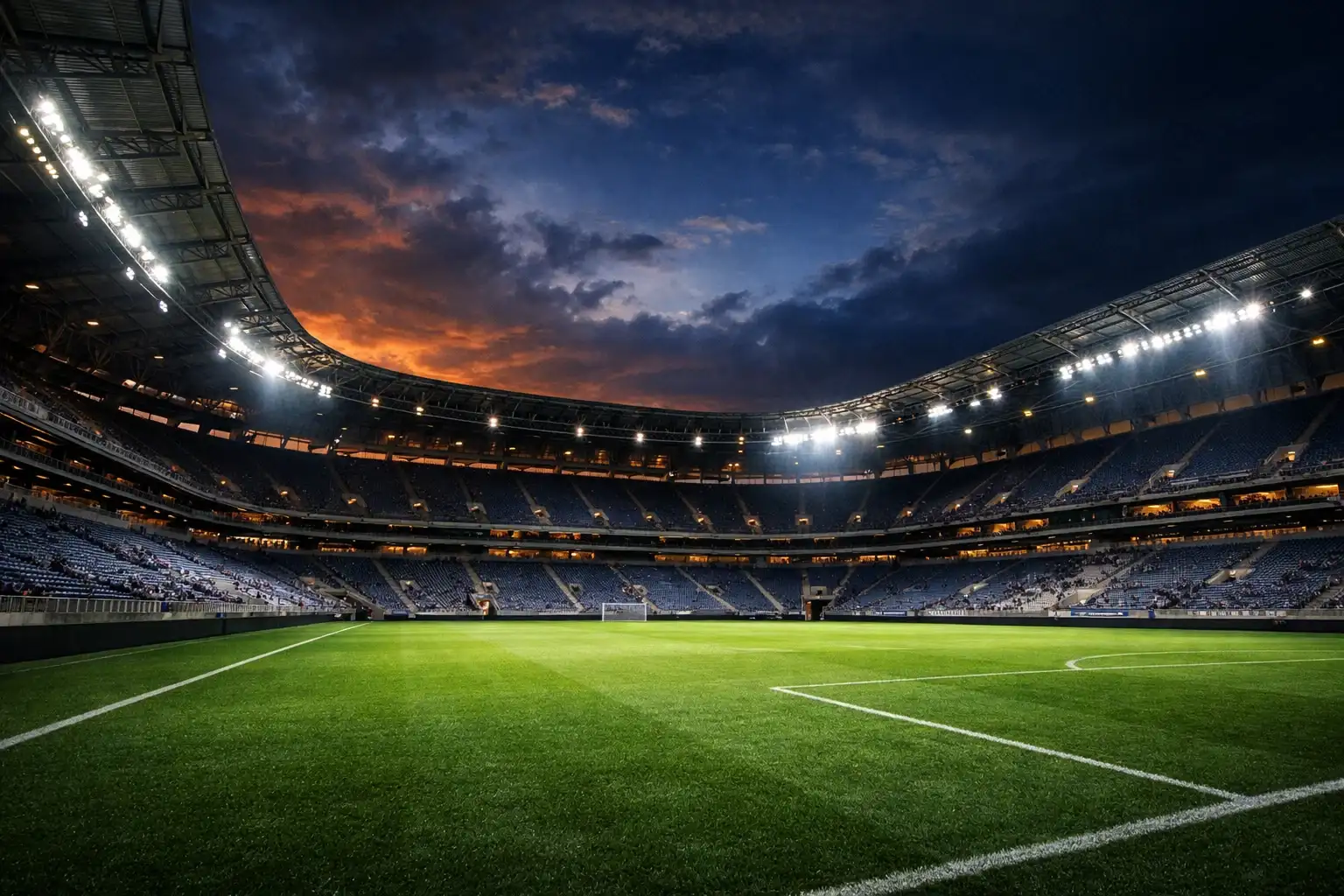 Fussballstadion bei Abenddämmerung mit beleuchteten Tribünen